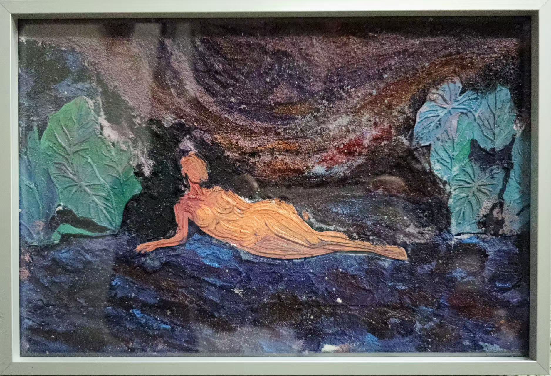 Mixed-media artwork: reclining orange figure in a landscape